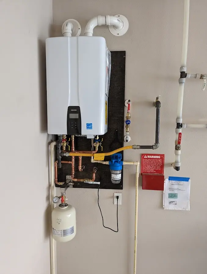 Professional plumber installing copper piping in a Springville home